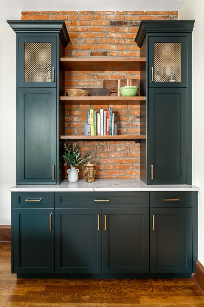 Original brick wall preserved for its color, texture, and architectural interest. Pantry cabinets painted with Sherwin Williams SW 6216 Jasper.