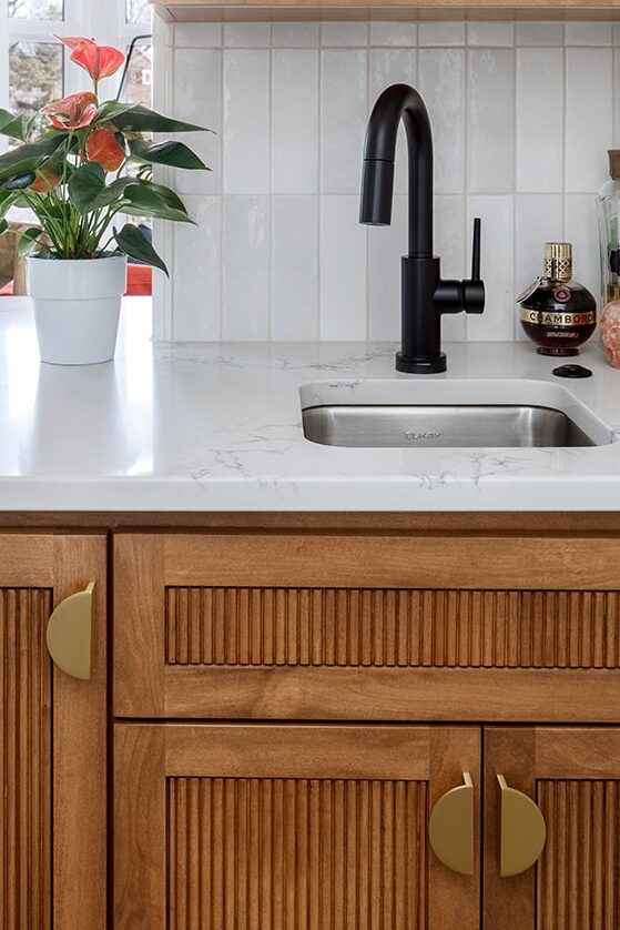 Reed detail inset into shaker-style cabinet doors adds depth and dimension. 